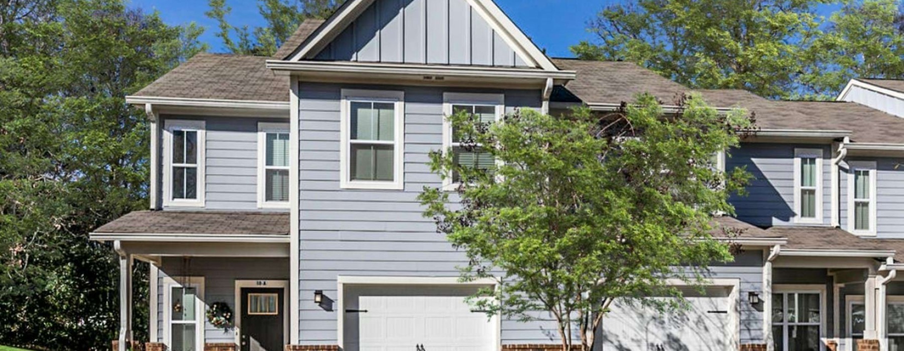 a house with a garage and trees